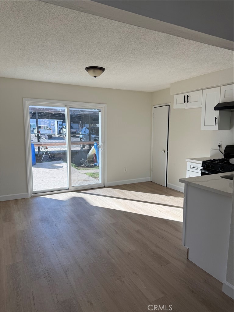 558 South Benjamin Street Rialto, CA 92376 - Photo 10 of 25 a view of a kitchen with wooden floor and electronic appliances