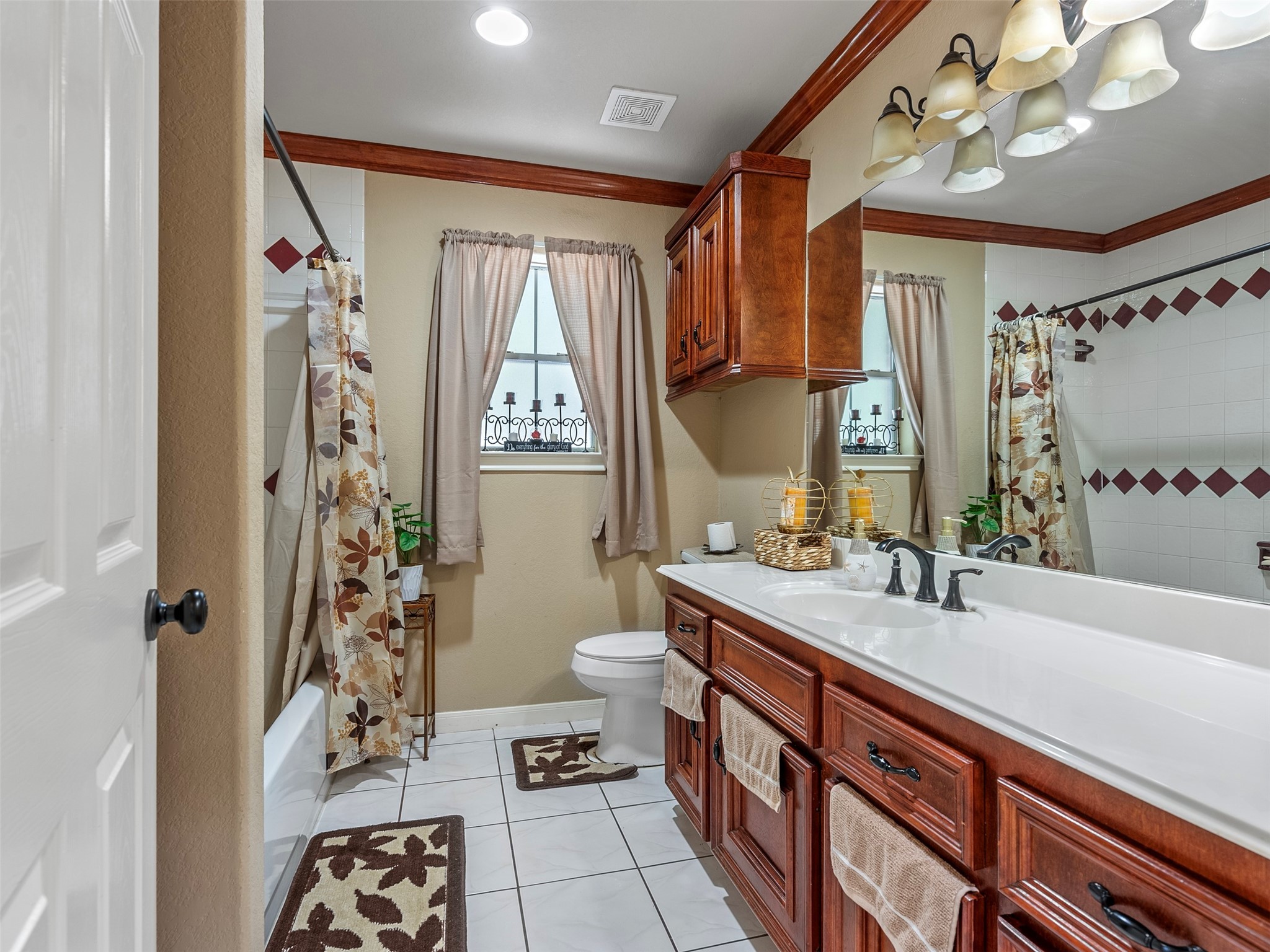 21007 Cook Road Tomball, TX 77377 - Photo 23 of 31 a spacious bathroom with a double vanity sink a large mirror and a shower