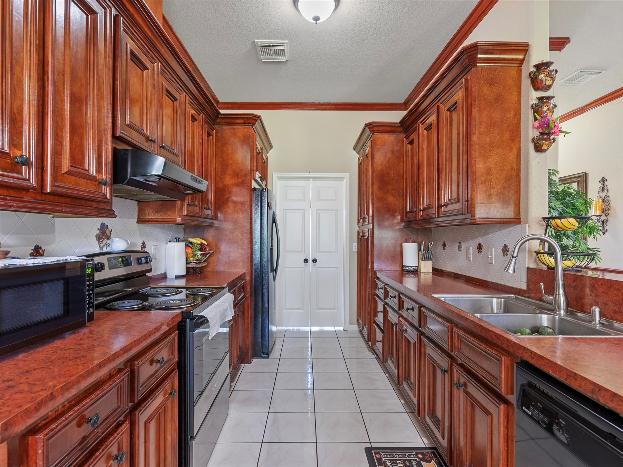 21007 Cook Road Tomball, TX 77377 - Photo 28 of 31 a kitchen with stainless steel appliances a sink and a stove
