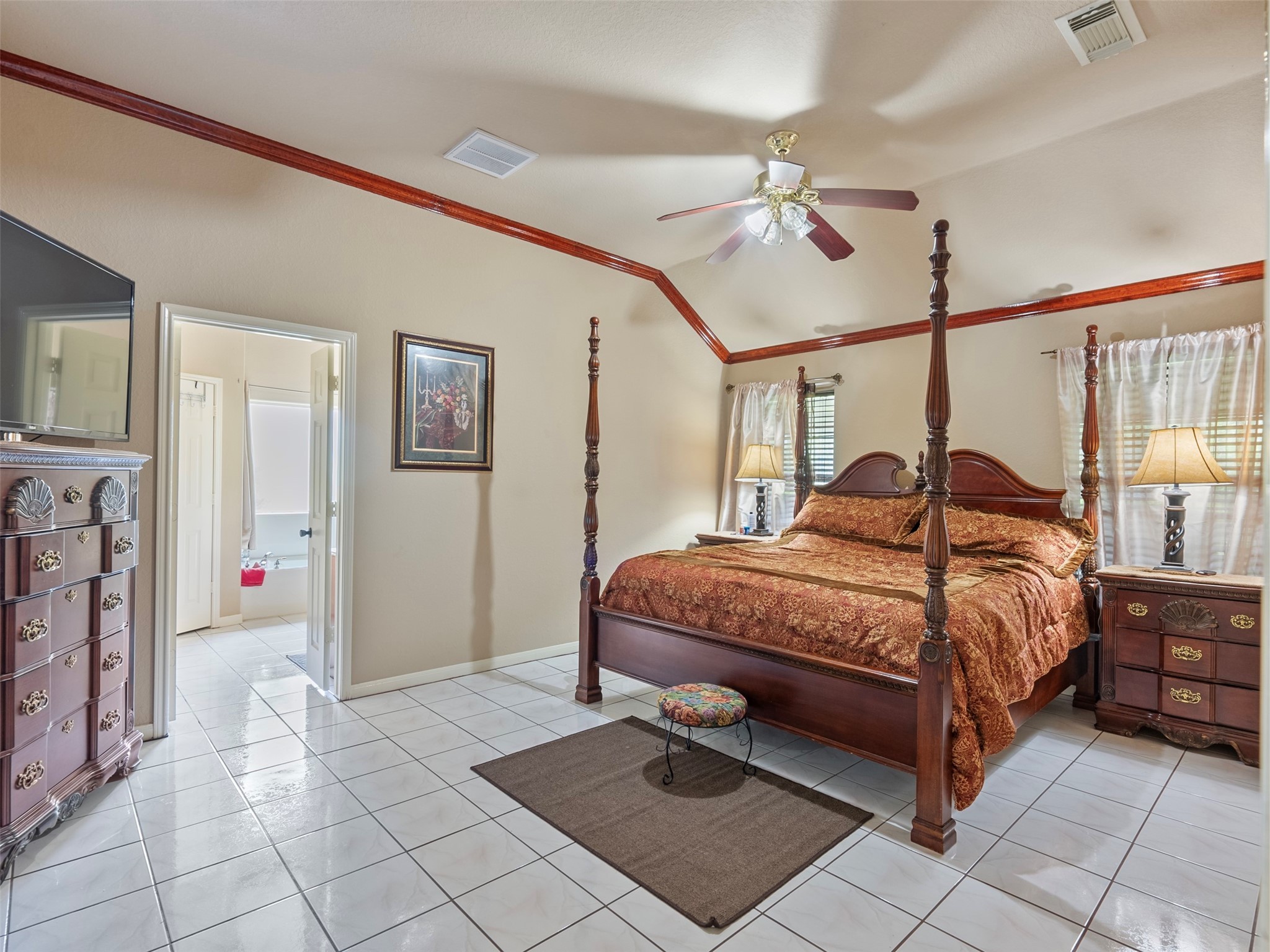 21007 Cook Road Tomball, TX 77377 - Photo 31 of 31 a bedroom with a bed and a chandelier