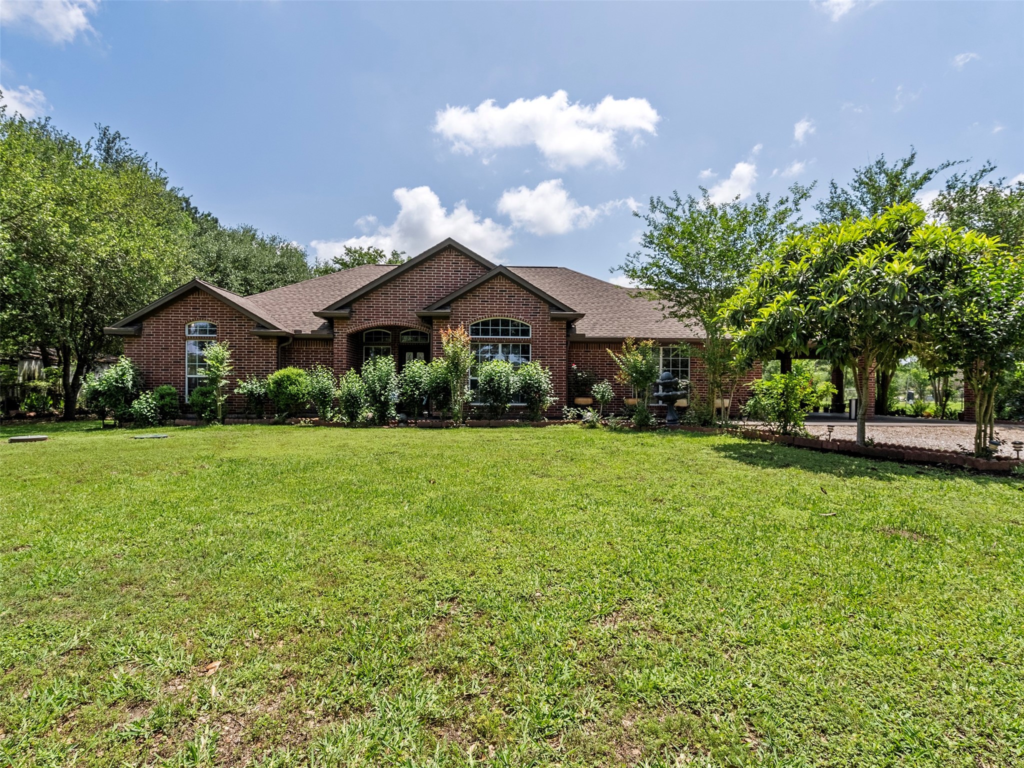 21007 Cook Road Tomball, TX 77377 - Photo 8 of 31 a front view of a house with garden