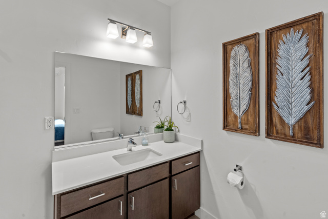 1122 South 1790th West, Unit 1 St. George, UT 84770 - Photo 15 of 37 Bathroom vanity featuring a rectangular undermount sink, a chrome-finish faucet, and a light-toned countertop