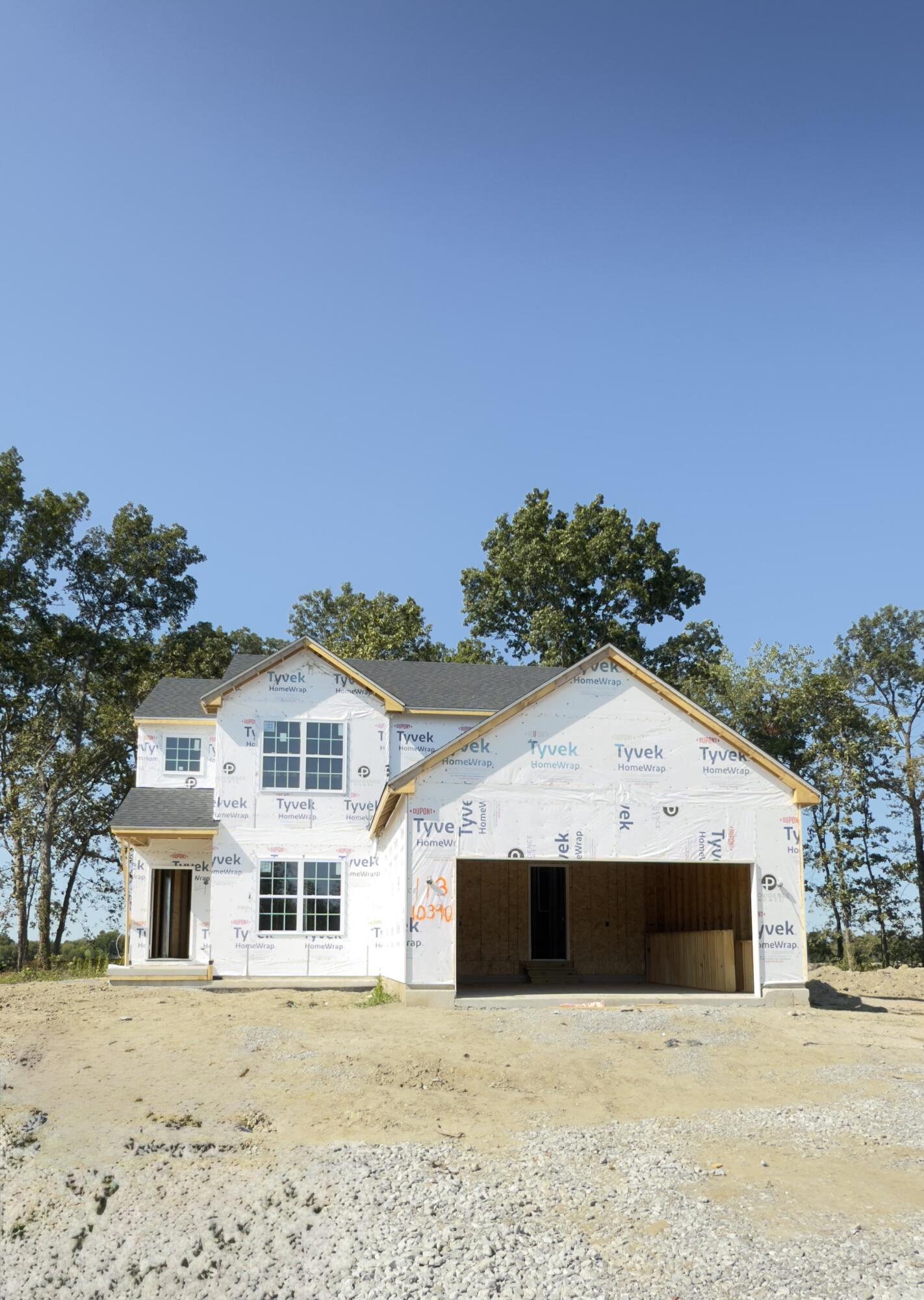 a view of a white house with a yard