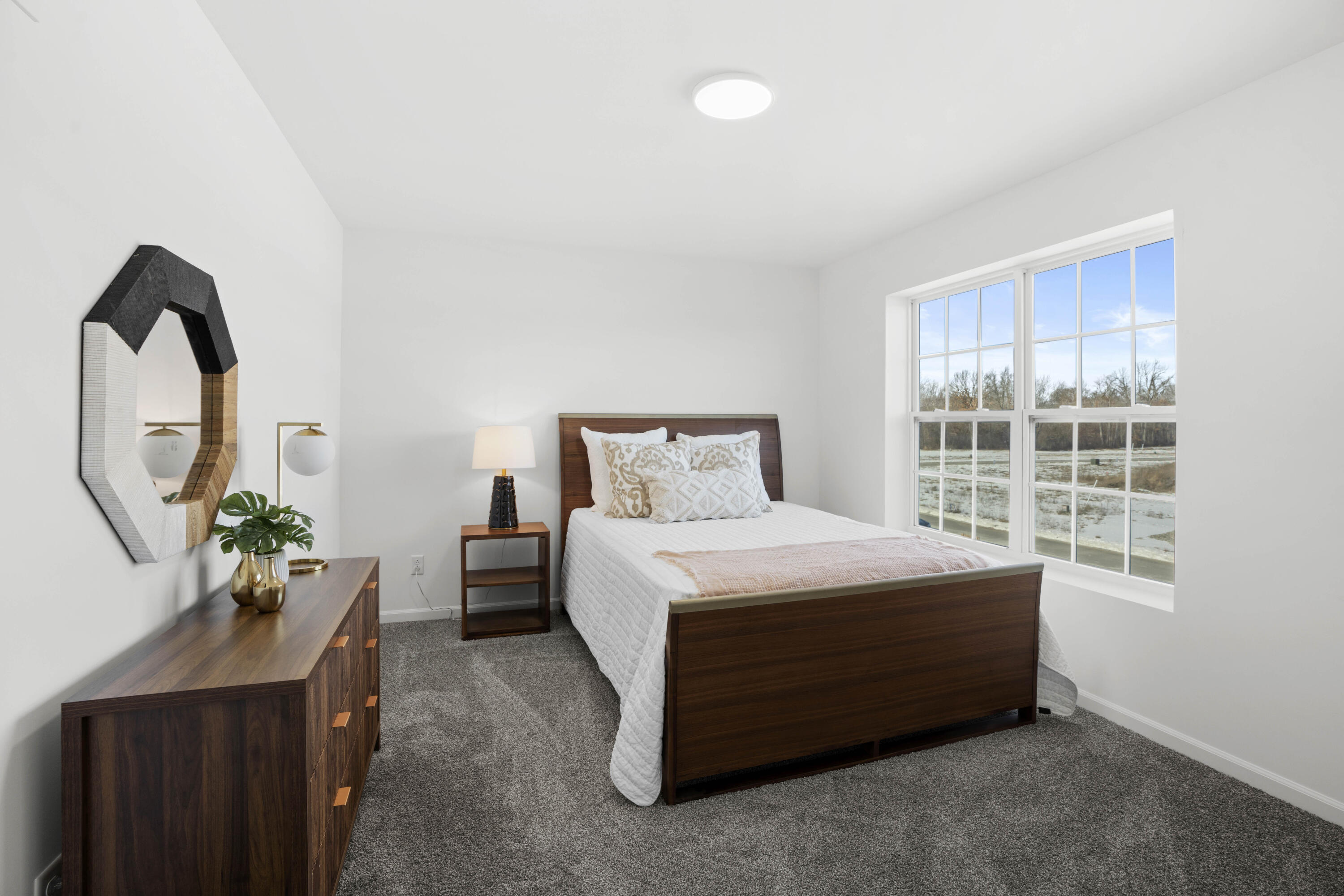 10390 California Street Crown Point, IN 46307 - Photo 23 of 26 a bed sitting in a bedroom next to a window