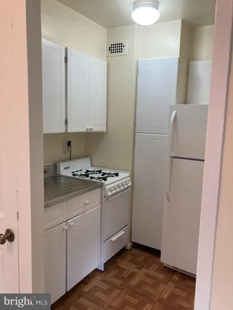 a kitchen with stainless steel appliances granite countertop a refrigerator and a stove