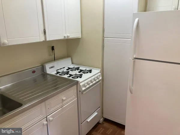 a kitchen with appliances and cabinets