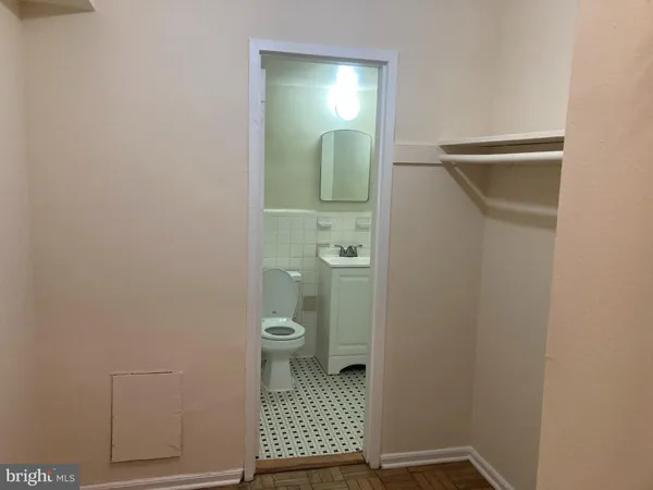 a bathroom with a sink mirror and toilet