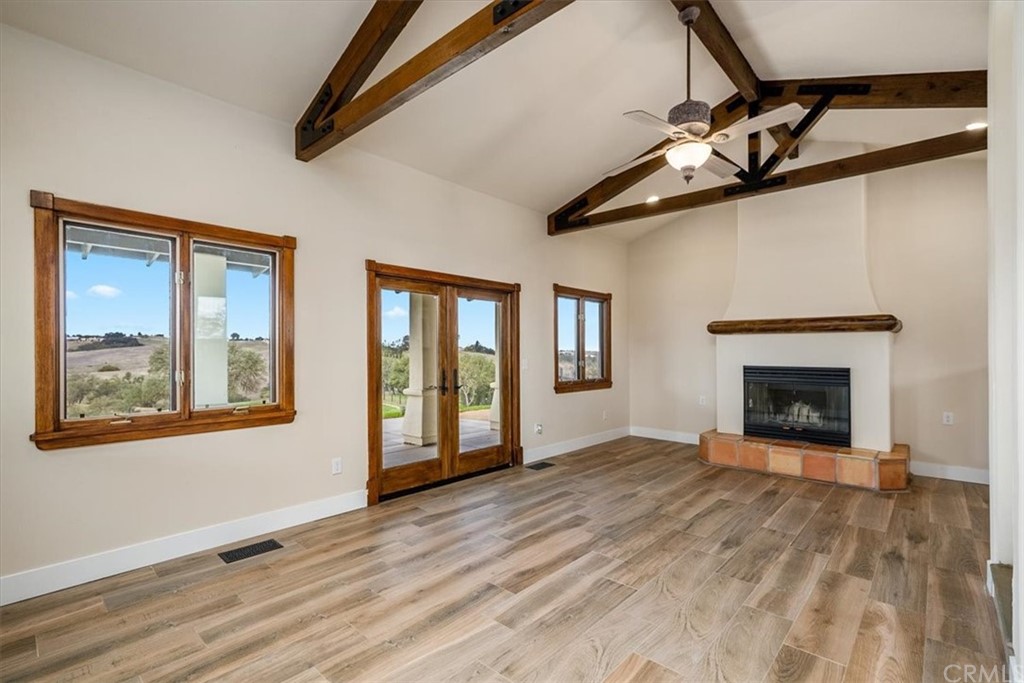 5920 Iron Gate Road Creston, CA 93432 - Photo 15 of 57 a view of an empty room with wooden floor fireplace and a window