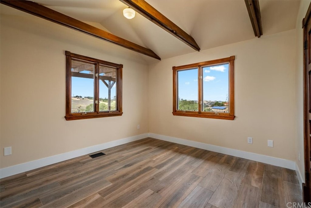 5920 Iron Gate Road Creston, CA 93432 - Photo 28 of 57 a view of an empty room with wooden floor and a window