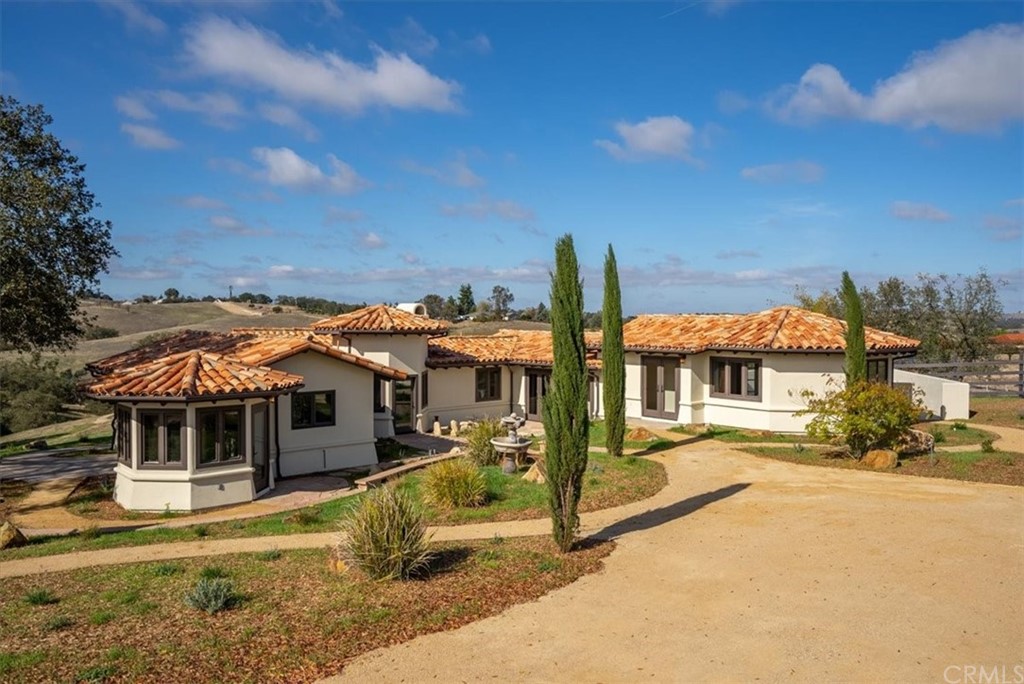 5920 Iron Gate Road Creston, CA 93432 - Photo 3 of 57 a front view of a house with a yard table and chairs