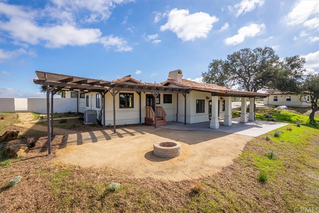 5920 Iron Gate Road Creston, CA 93432 - Photo 31 of 57 a front view of a house with a yard patio and fire pit