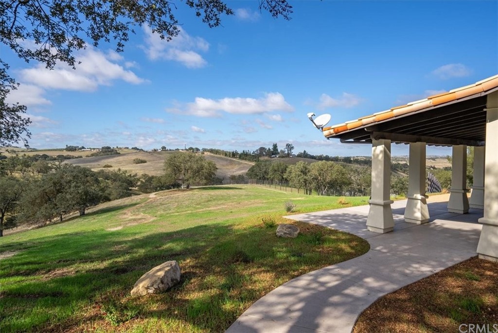 5920 Iron Gate Road Creston, CA 93432 - Photo 34 of 57 a view of a patio with a table and chairs under an umbrella