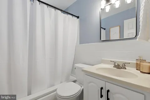 a bathroom with a sink a toilet and mirror