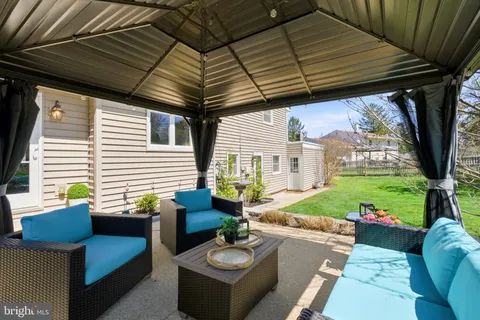 a view of a patio with couches chairs and a potted plant