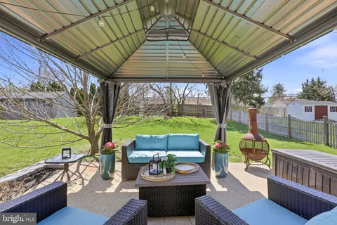 a outdoor living space with patio furniture and a garden