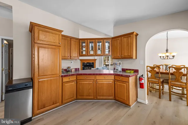 a kitchen with granite countertop stainless steel appliances and wooden cabinets