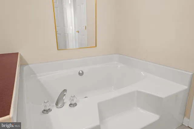a bathroom with a granite countertop toilet and a shower