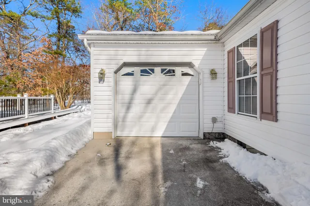 a view of a house with snow on the road