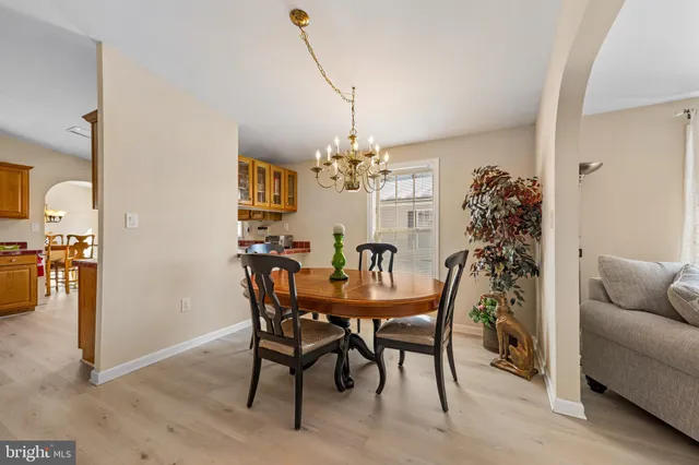a view of a dining room with furniture and chandelier