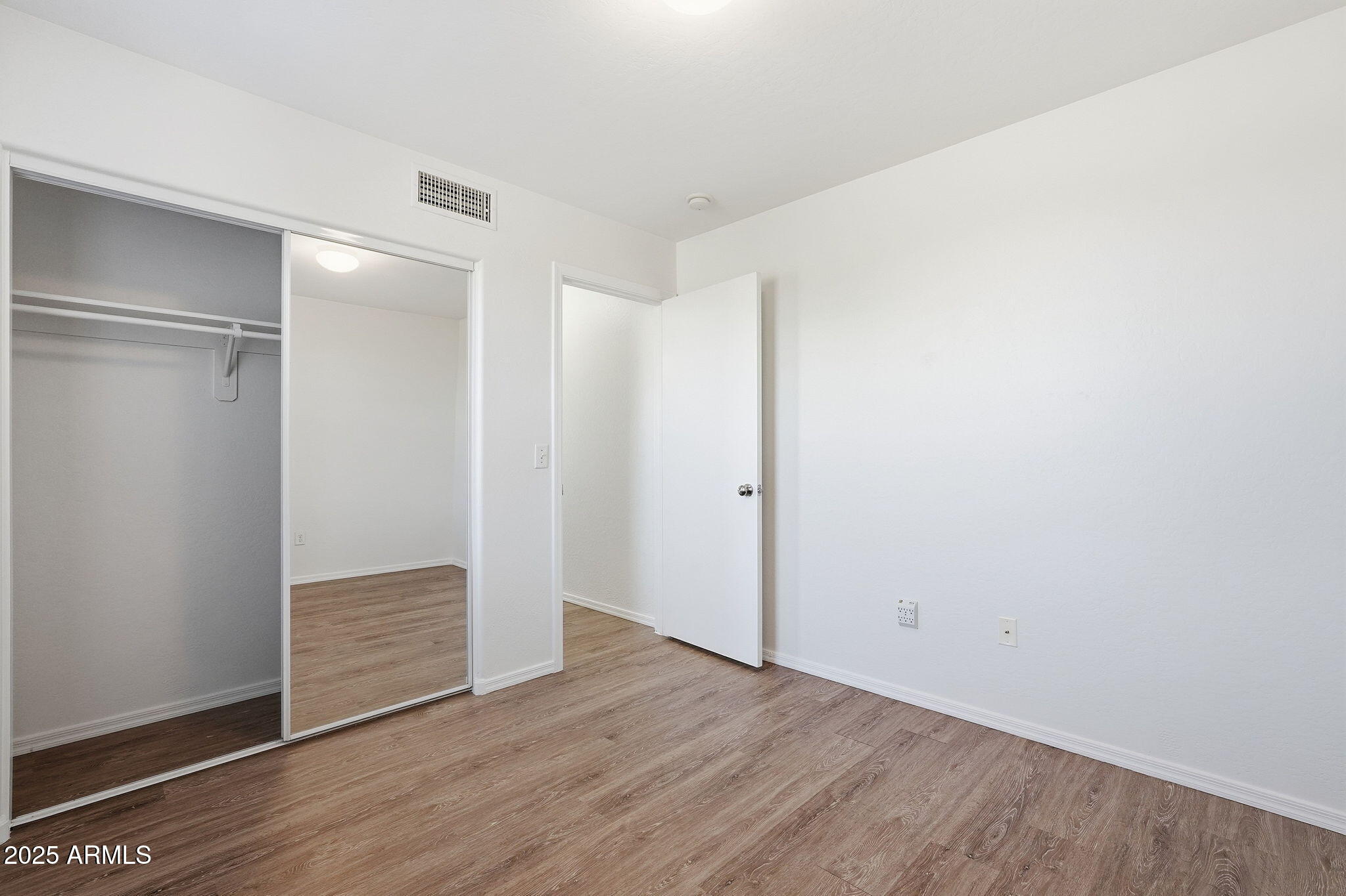 9233 East Neville Avenue, Unit 1136 Mesa, AZ 85209 - Photo 19 of 29 a view of an empty room with wooden floor