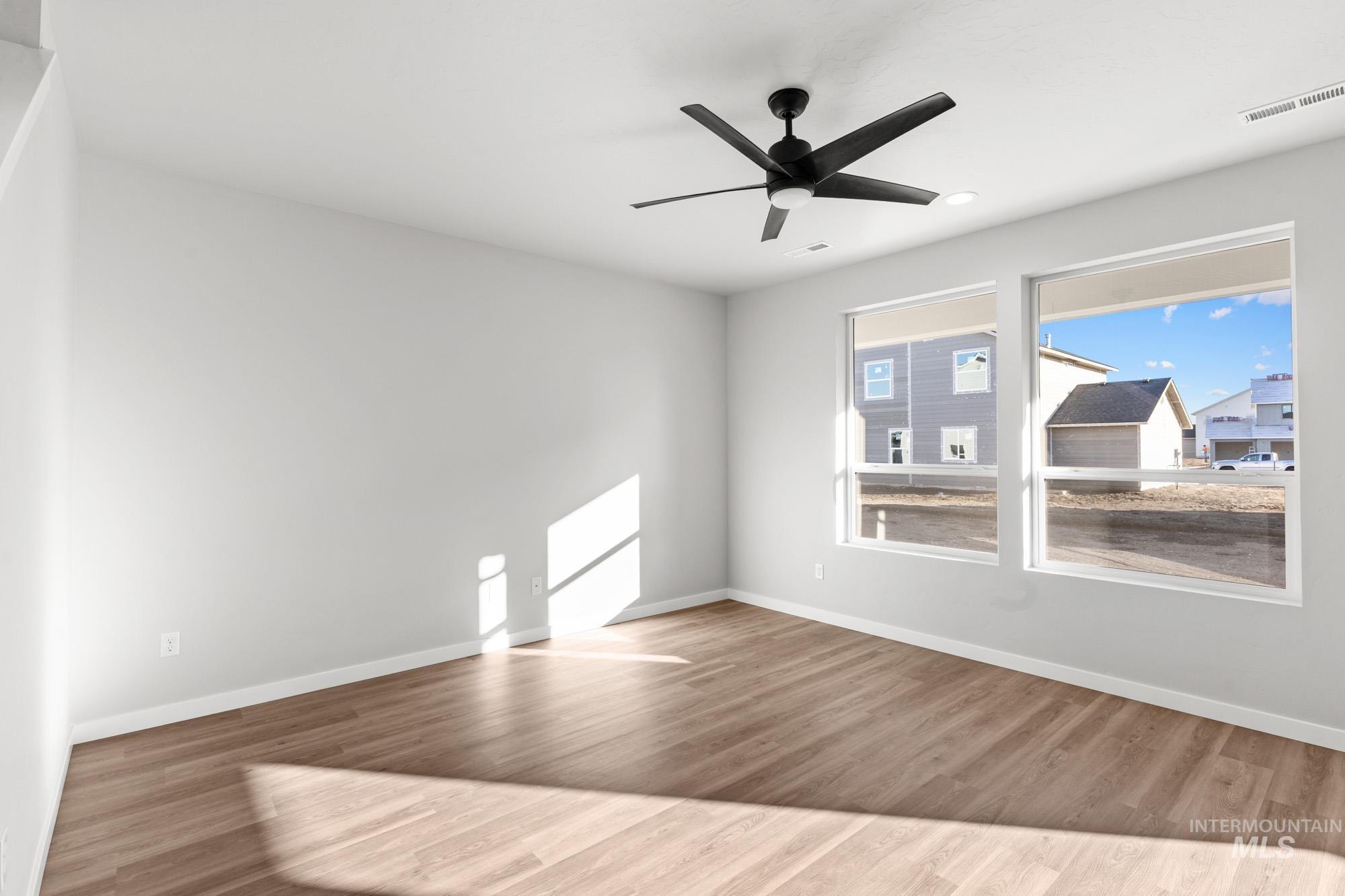 13713 Judson Street Caldwell, ID 83607 - Photo 7 of 24 Spare room featuring wood finished floors and ceiling fan