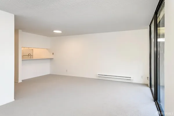 a view of an empty room with glass door