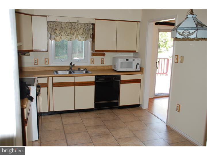 185 Old Spring Road Coatesville, PA 19320 - Photo 3 of 16 a kitchen with stainless steel appliances a sink stove and cabinets