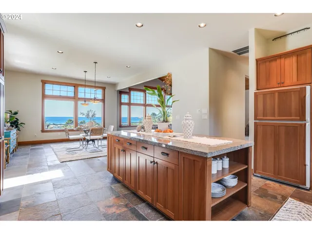 a kitchen with counter top space and wooden floor