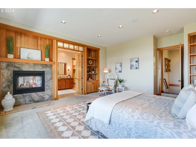 a spacious bedroom with a bed and a fireplace