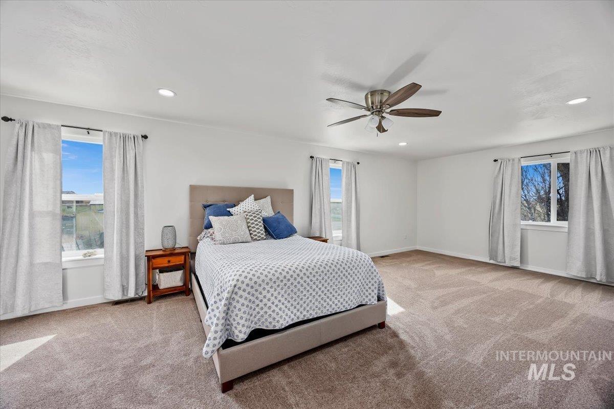 3536 North 2300 E Road Filer, ID 83328 - Photo 16 of 47 Bedroom featuring light colored carpet, ceiling fan, and recessed lighting
