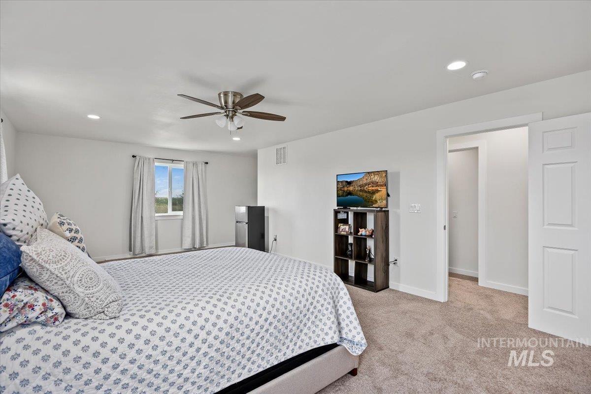 3536 North 2300 E Road Filer, ID 83328 - Photo 17 of 47 Bedroom with light carpet, recessed lighting, and ceiling fan