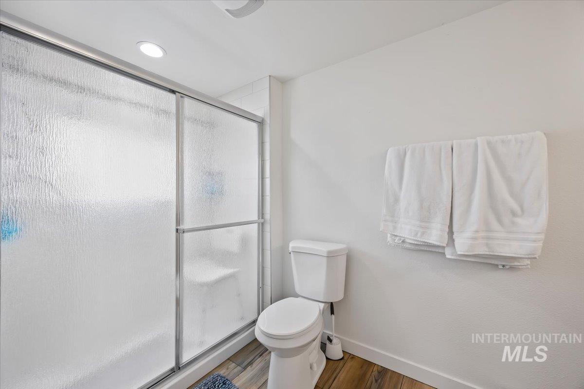 3536 North 2300 E Road Filer, ID 83328 - Photo 24 of 47 Full bath featuring a stall shower, wood finished floors, and recessed lighting