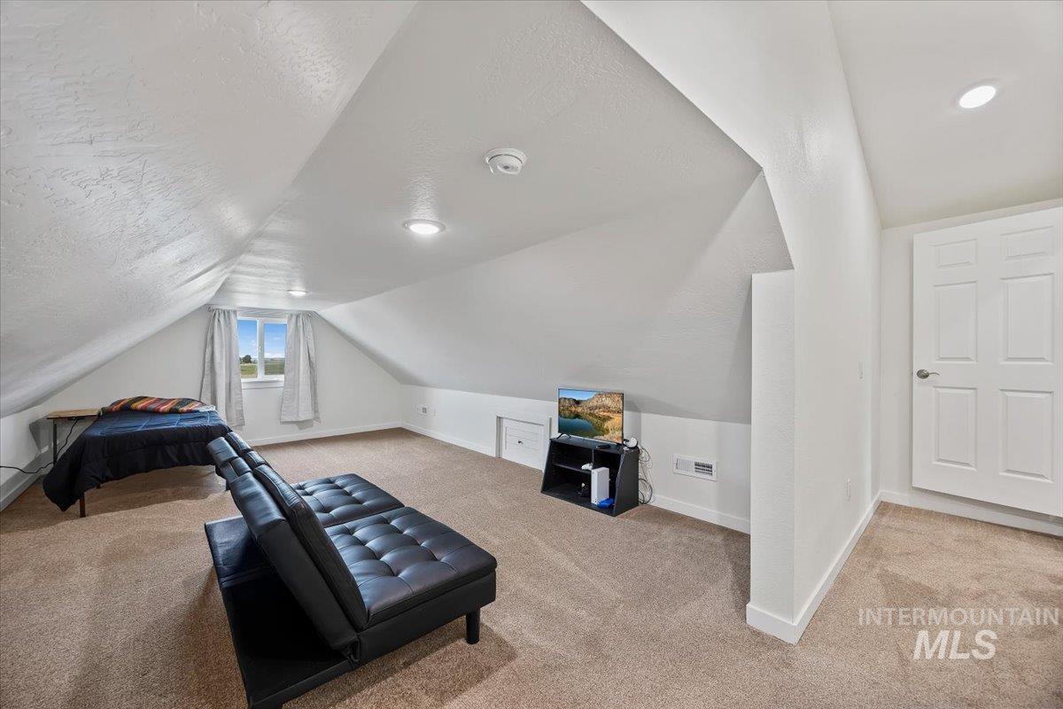 3536 North 2300 E Road Filer, ID 83328 - Photo 25 of 47 Exercise room featuring light carpet and a textured ceiling