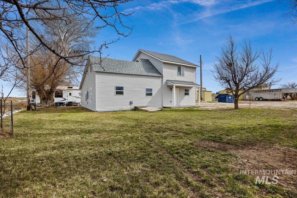 3536 North 2300 E Road Filer, ID 83328 - Photo 3 of 47 Back of house with roof with shingles, a yard, and a patio