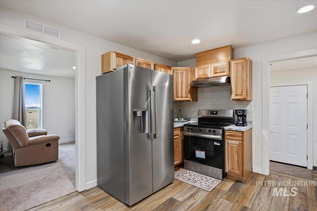 3536 North 2300 E Road Filer, ID 83328 - Photo 7 of 47 Kitchen featuring stainless steel appliances, recessed lighting, light wood-style floors, light wood finish cabinetry, and backsplash