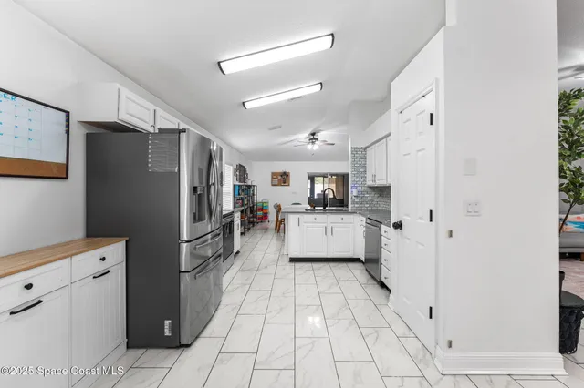 a kitchen with refrigerator and cabinets