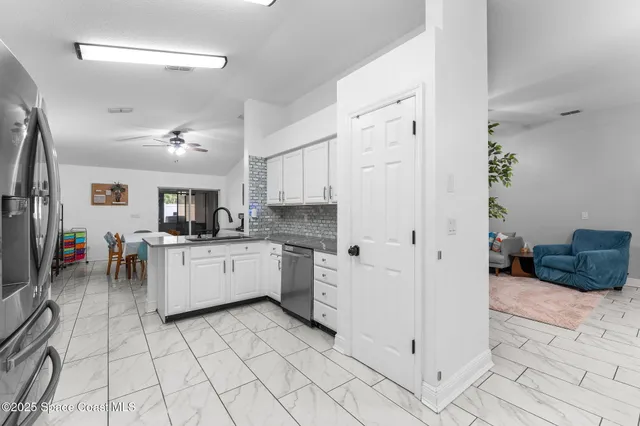 a kitchen with white cabinets and white appliances