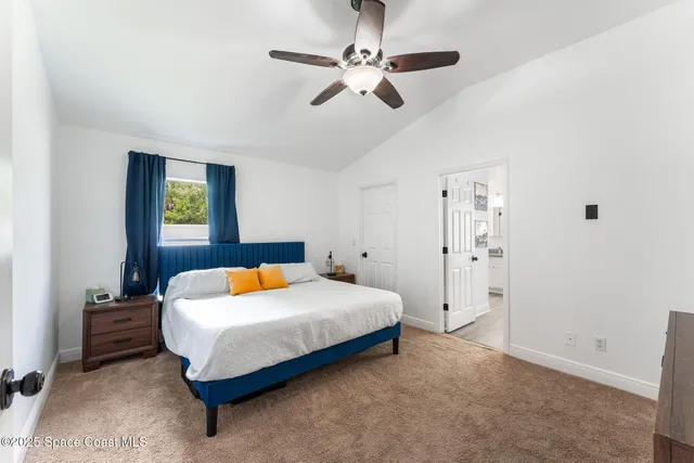 a bedroom with a bed and a ceiling fan