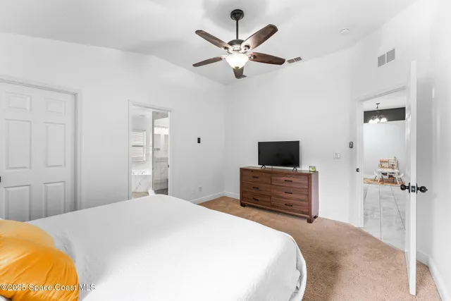 a bedroom with a bed and a television