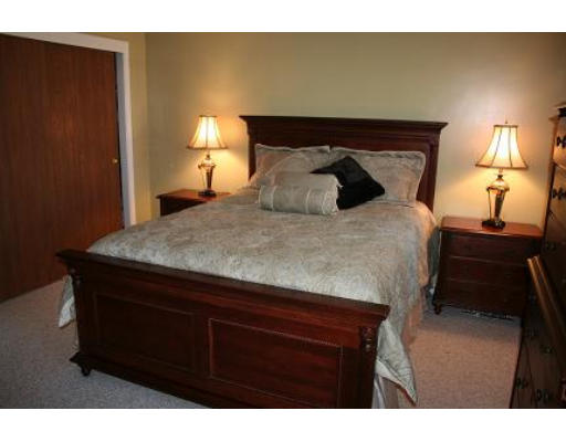 364 Neponset Street, Unit G Canton, MA 02021 - Photo 12 of 14 a bed sitting in a bedroom next to a lamp