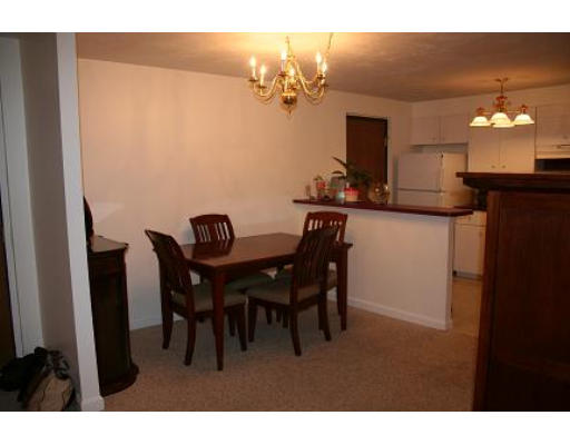364 Neponset Street, Unit G Canton, MA 02021 - Photo 5 of 14 a view of a dining room with furniture and chandelier