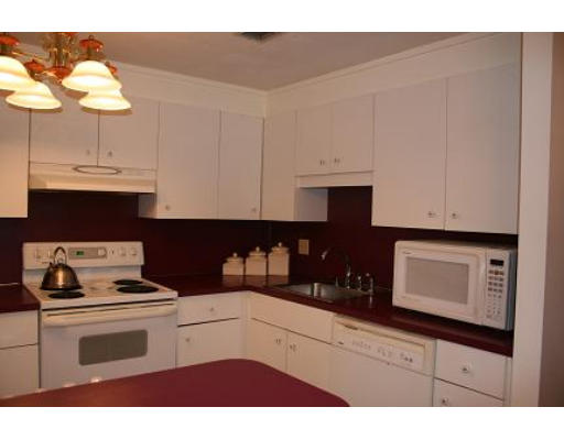 364 Neponset Street, Unit G Canton, MA 02021 - Photo 8 of 14 a kitchen with a white cabinets and white appliances