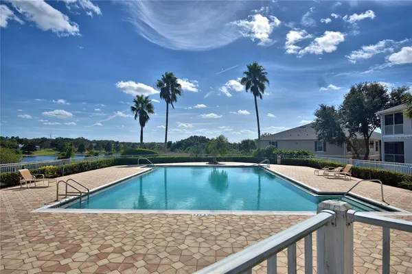 a view of a swimming pool with a lounge chairs