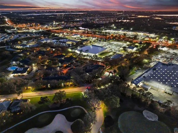 an aerial view of residential houses with outdoor space and swimming pool