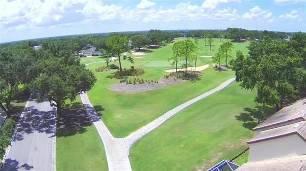 an aerial view of a golf course with parking space