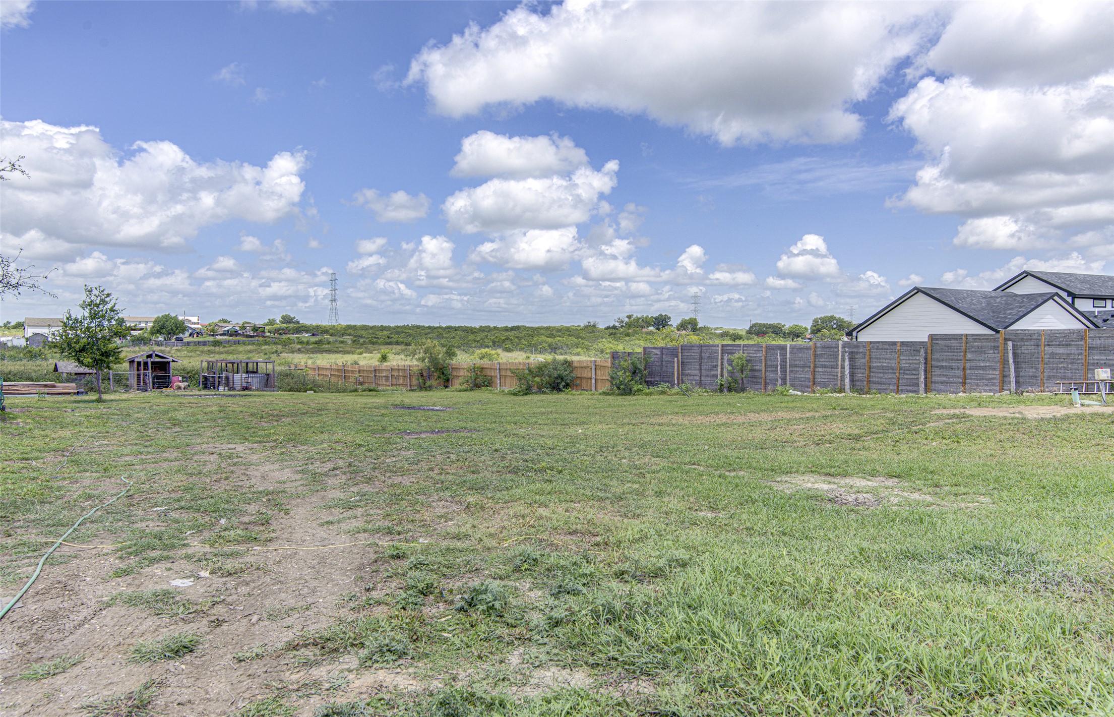 445 Rancho Linda Drive Lockhart, TX 78644 - Photo 7 of 26 A spacious lot offering vast possibilities for new construction or outdoor enjoyment, with a natural wood privacy fence.