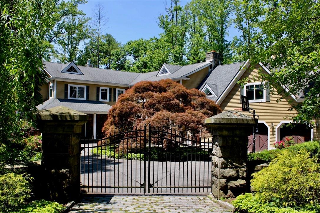 a front view of house with yard and trees