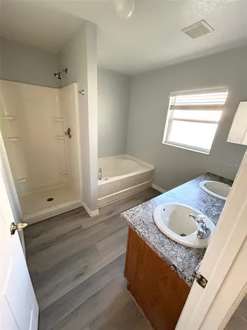 a bathroom with a tub sink and mirror