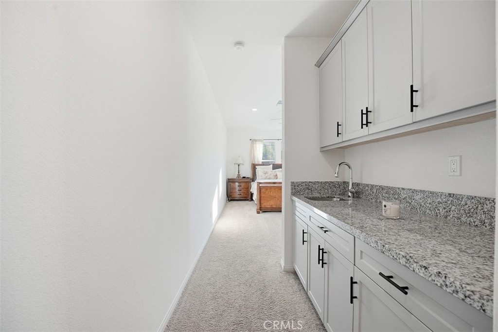 7608 Citrusmoon Court Riverside, CA 92507 - Photo 6 of 25 a large white kitchen with granite countertop a sink