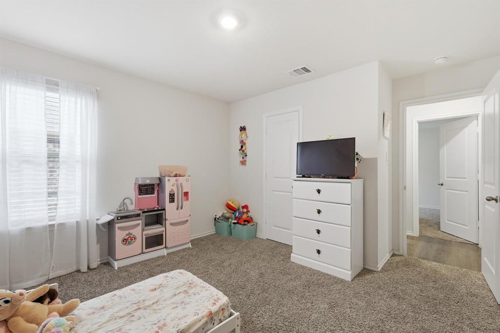 2416 Wildhaven Road Crandall, TX 75114 - Photo 25 of 35 a living room with furniture and a flat screen tv